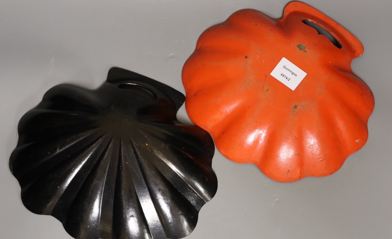Two early 20th century japanned scallop shell dishes. 29cm wide